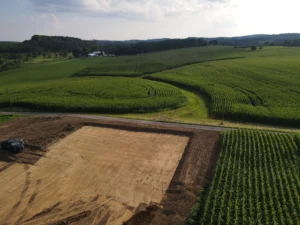 An aerial view of a farm field undergoing site development.